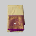 Cream coloured body with golden flower print semi kanchipuram silk saree with Purple border