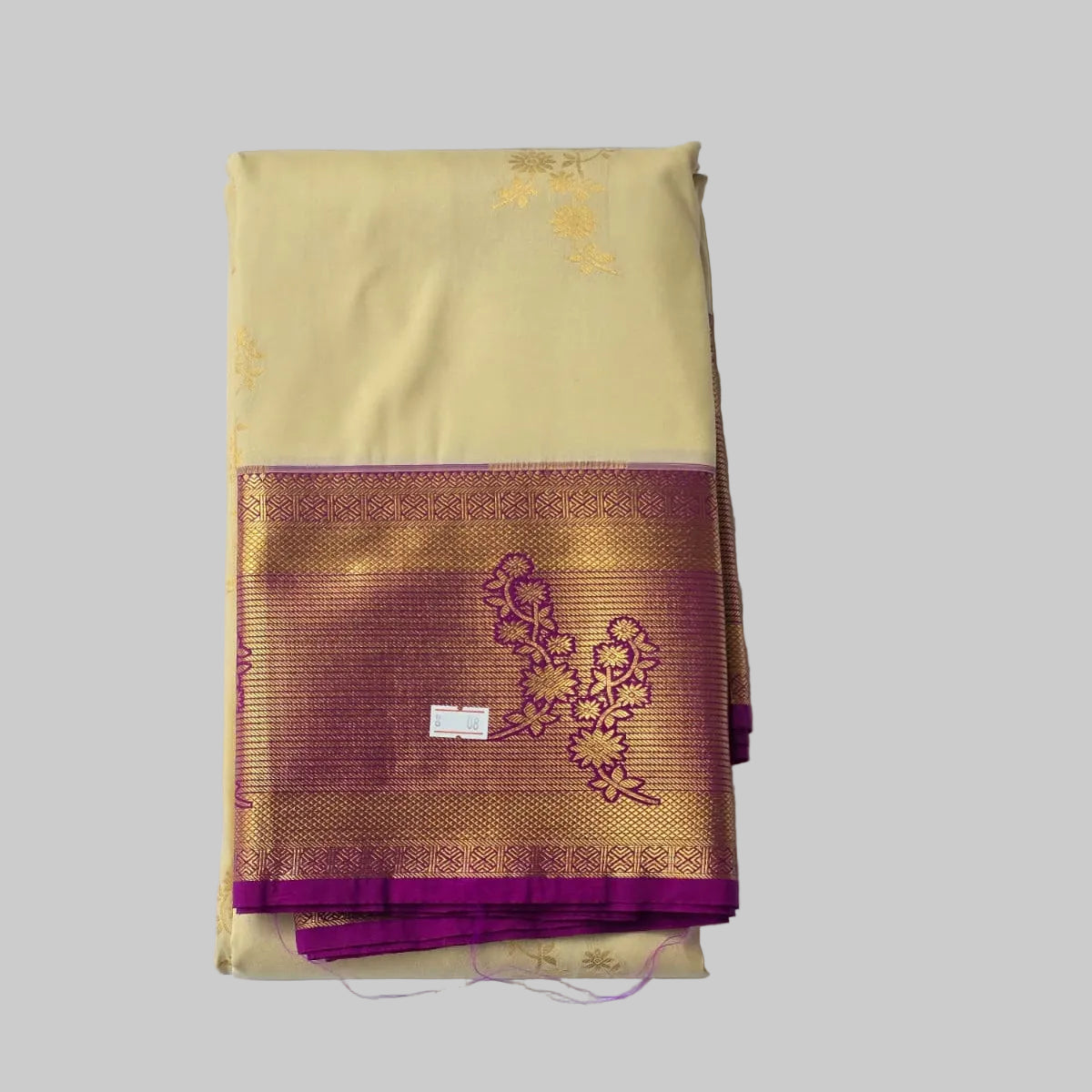 Cream coloured body with golden flower print semi kanchipuram silk saree with Purple border