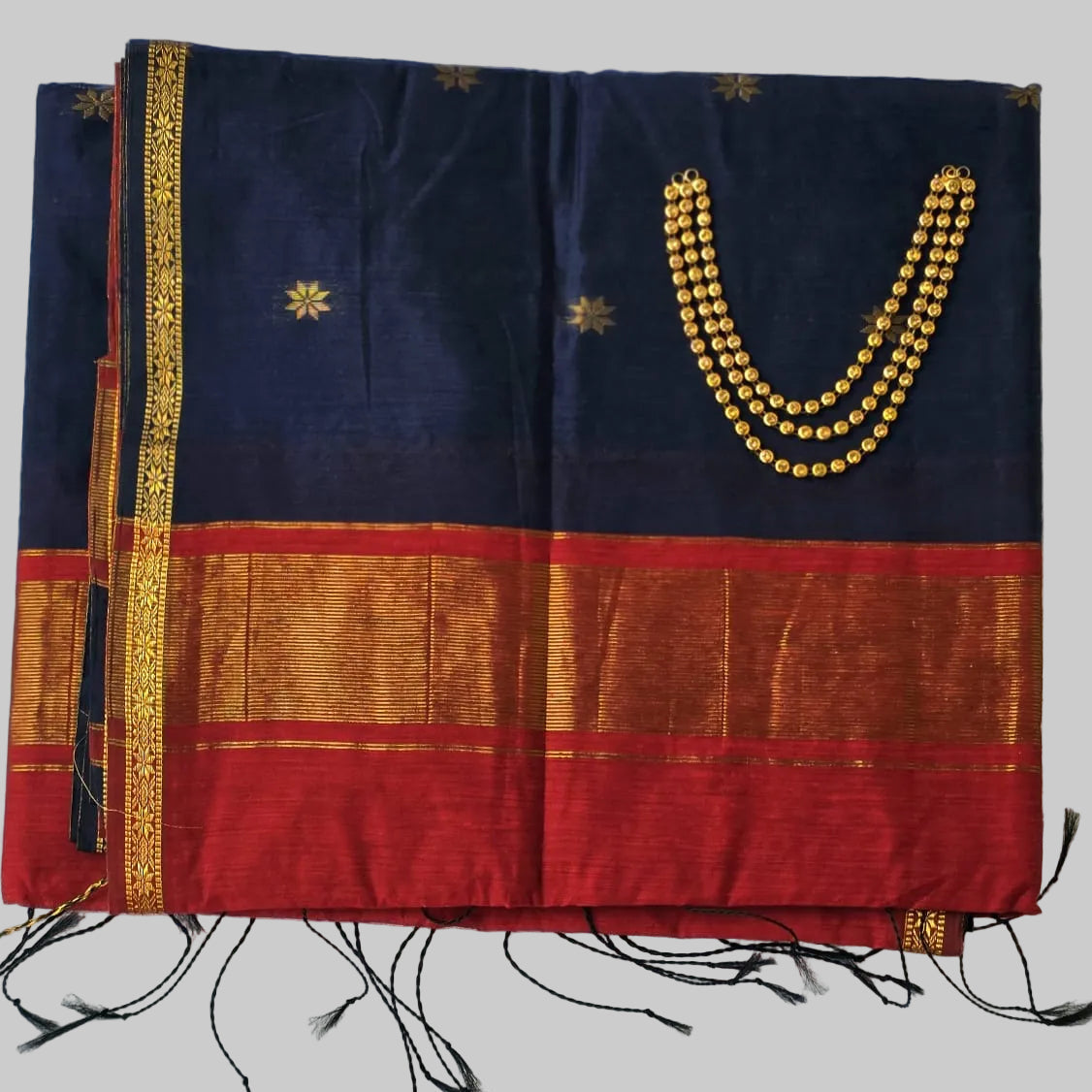 Navy blue cotton silk saree with bright red colour and golden border