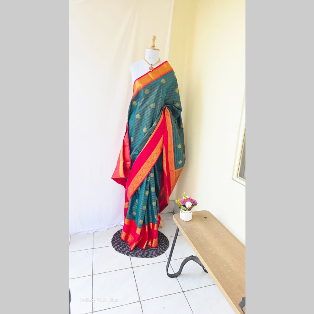 Dark green with golden stripes along flower butta semi kanchipuram silk saree with red double border