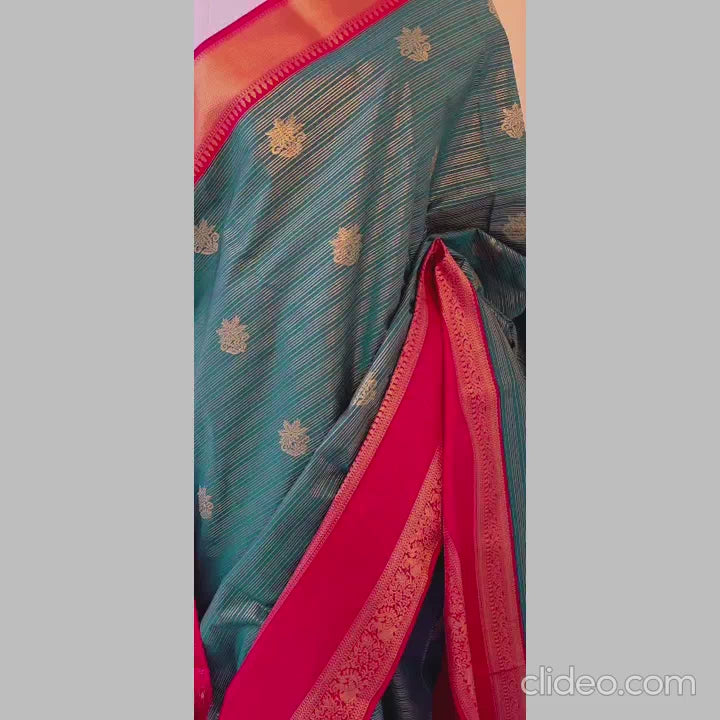 Dark green with golden stripes along flower butta semi kanchipuram silk saree with red double border
