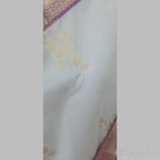 Cream coloured body with golden flower print semi kanchipuram silk saree with Purple border