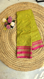 Parrot green colour semi silk saree with rani pink border