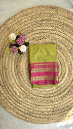 Parrot green colour semi silk saree with rani pink border