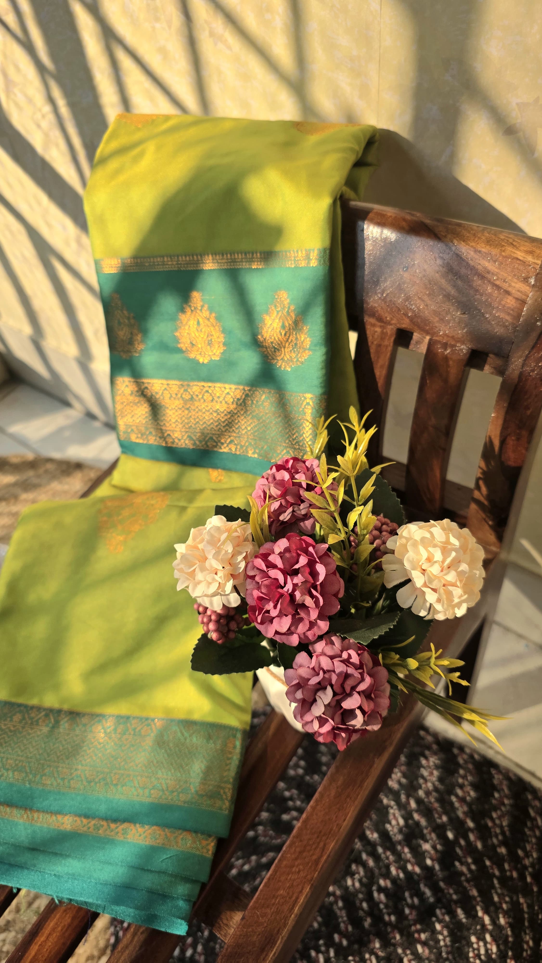 Light green semi kanchipuram silk saree with dark green border with golden buttas