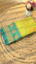 Light green semi kanchipuram silk saree with dark green border with golden buttas