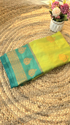 Light green semi kanchipuram silk saree with dark green border with golden buttas