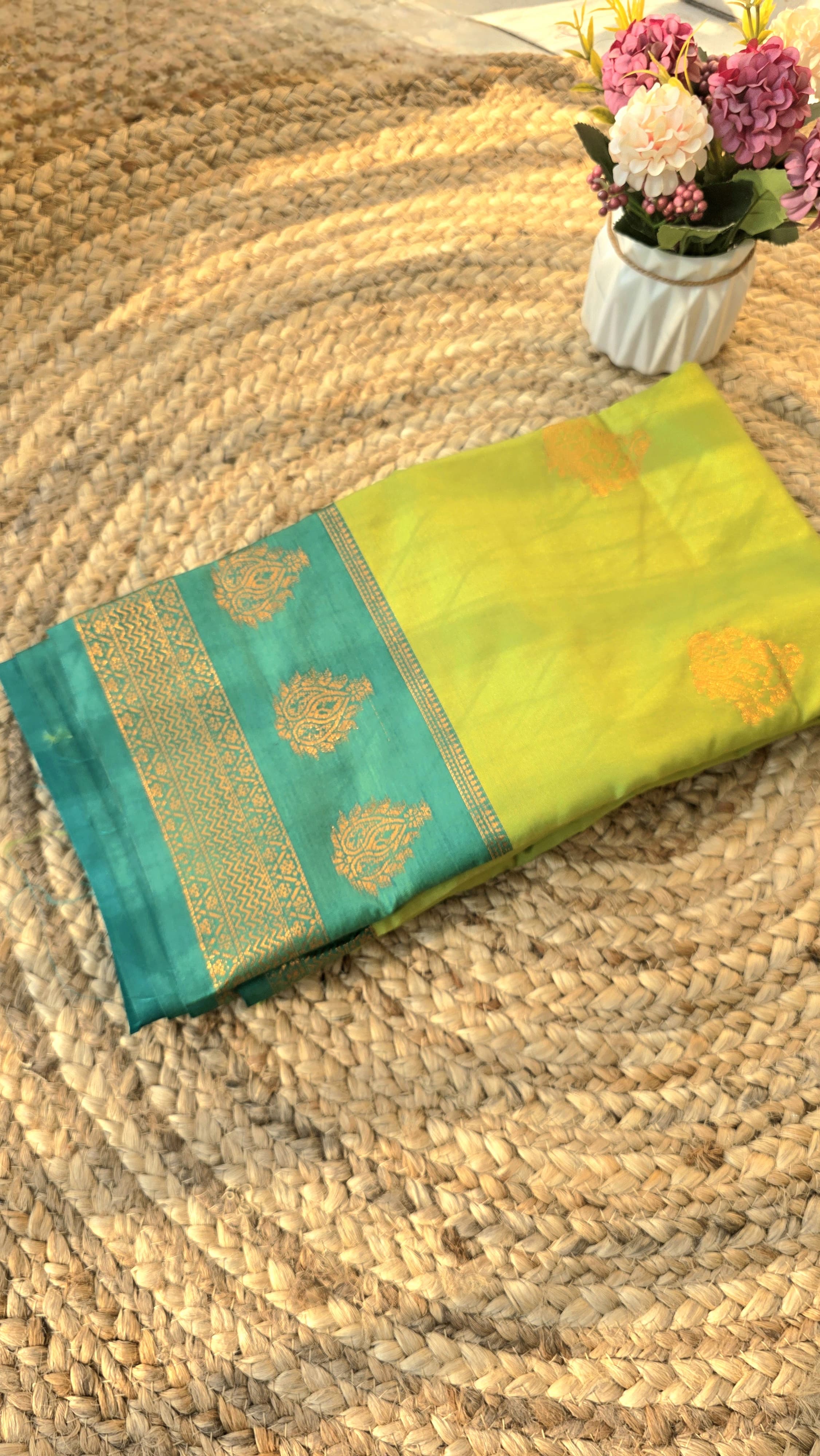 Light green semi kanchipuram silk saree with dark green border with golden buttas