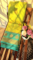 Light green semi kanchipuram silk saree with dark green border with golden buttas