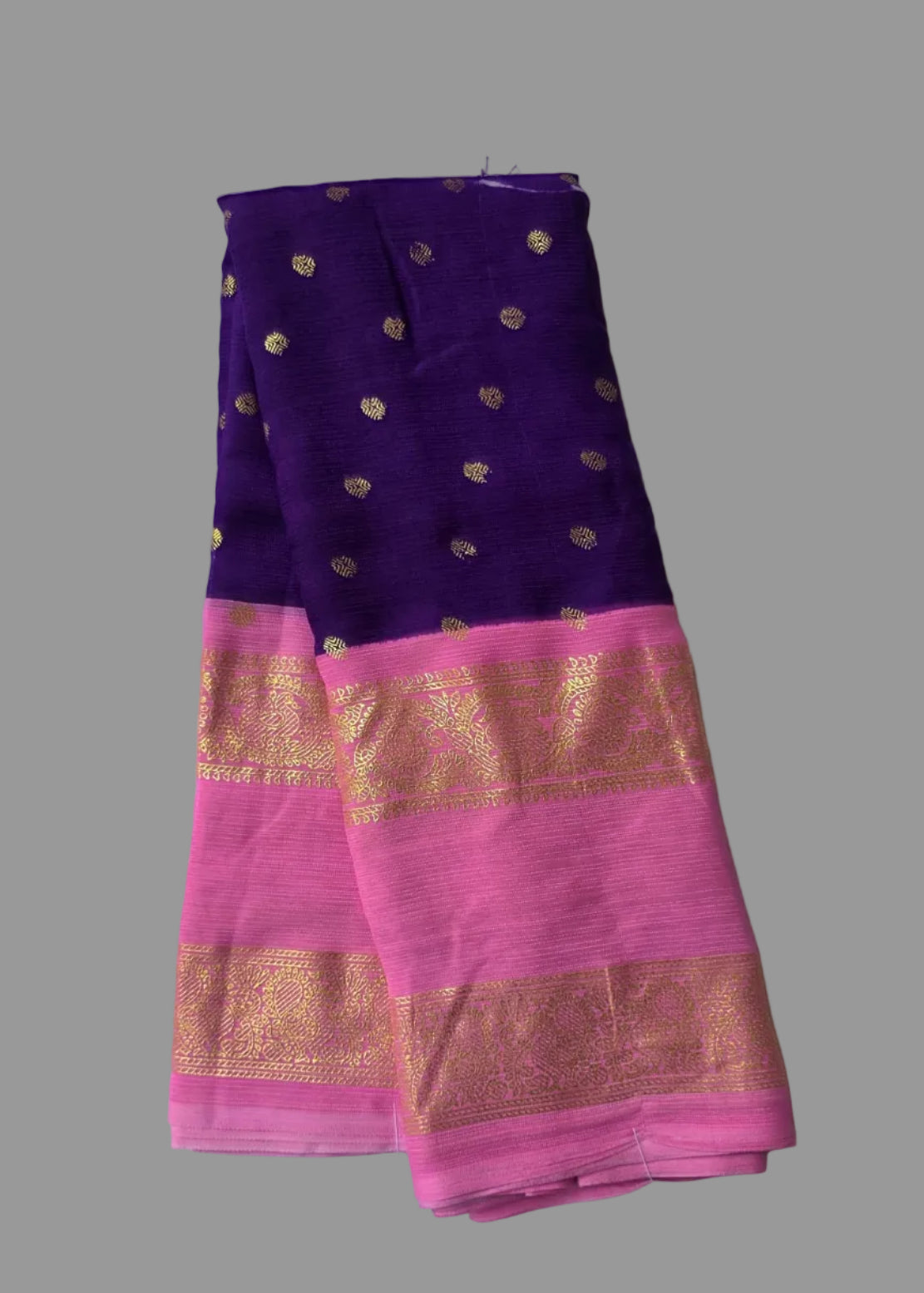Purple colour foil printed saree with pink border and golden buttas.