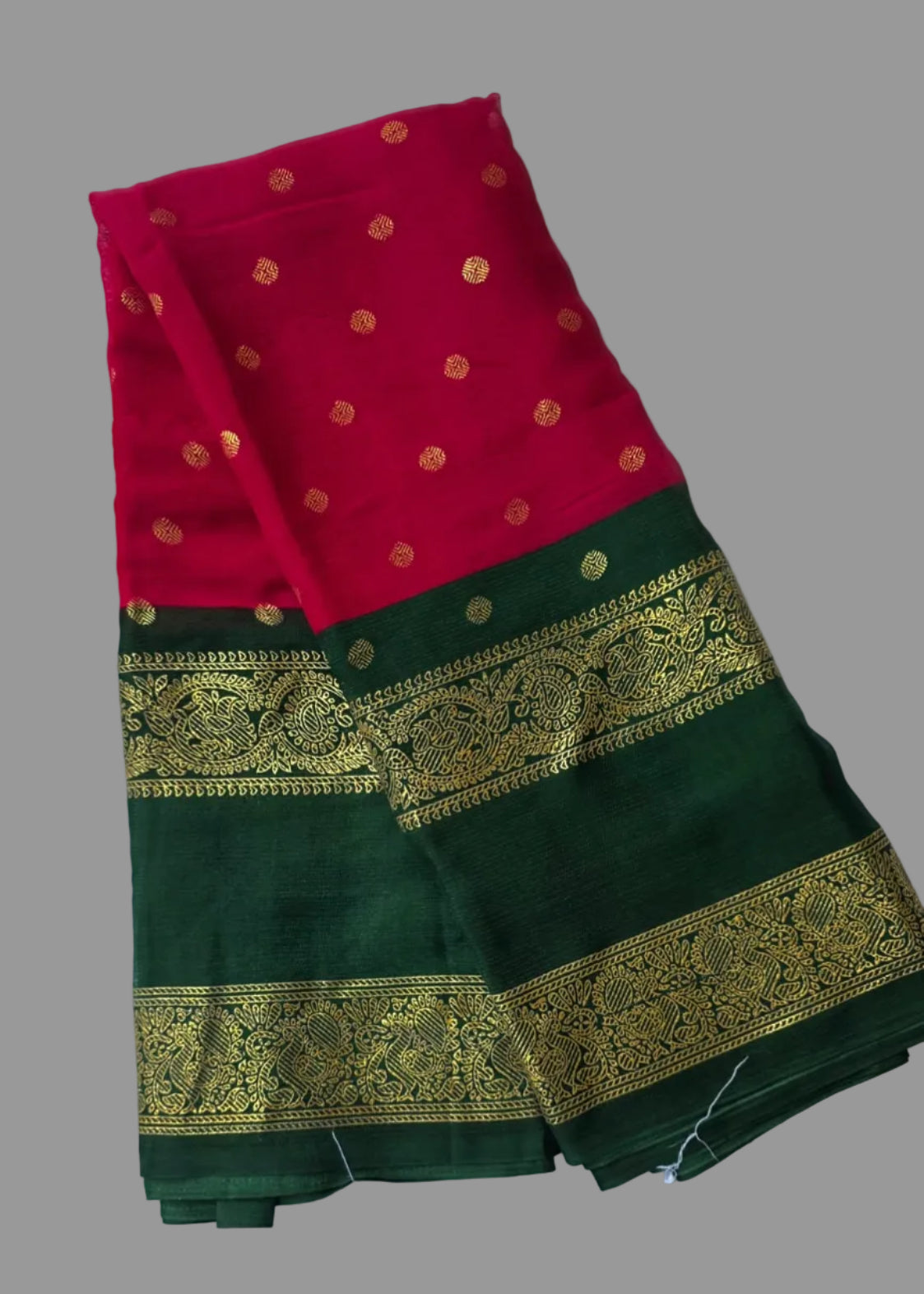 Rani pink colour foil printed saree with dark green border and golden buttas