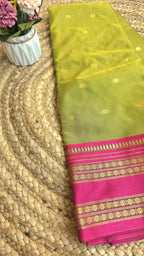 Parrot green colour semi silk saree with rani pink border